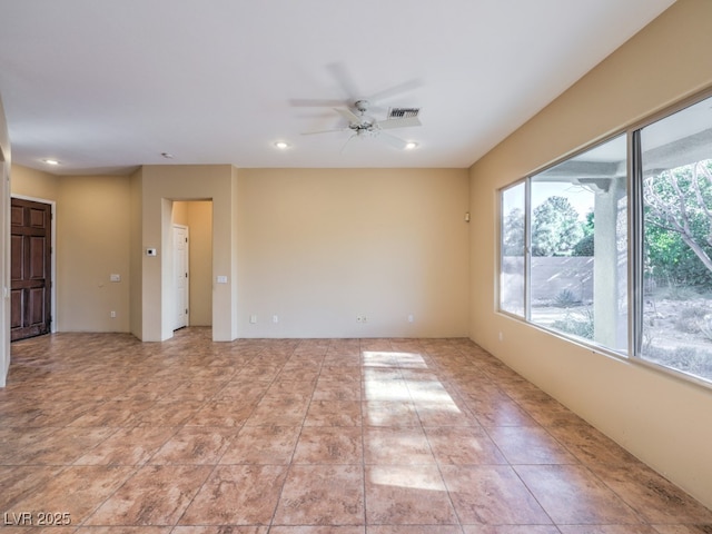 spare room with ceiling fan, plenty of natural light, and light tile patterned floors