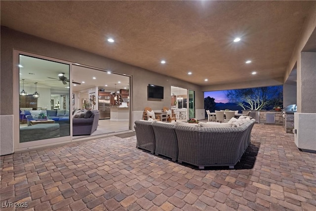 interior space with exterior kitchen, grilling area, and an outdoor hangout area