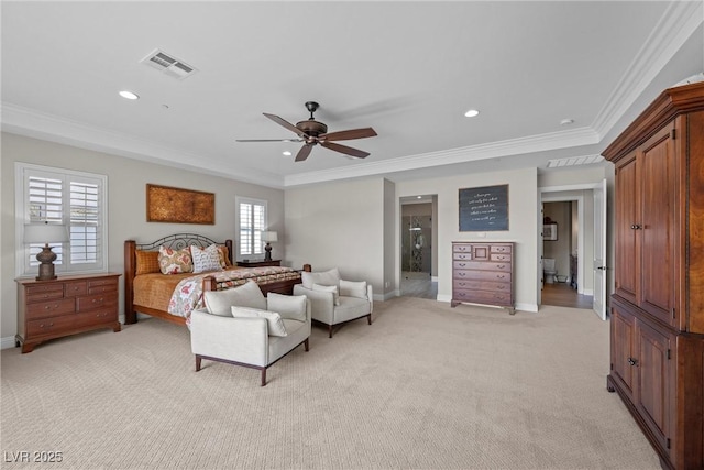 bedroom with ceiling fan, ensuite bathroom, light colored carpet, and multiple windows