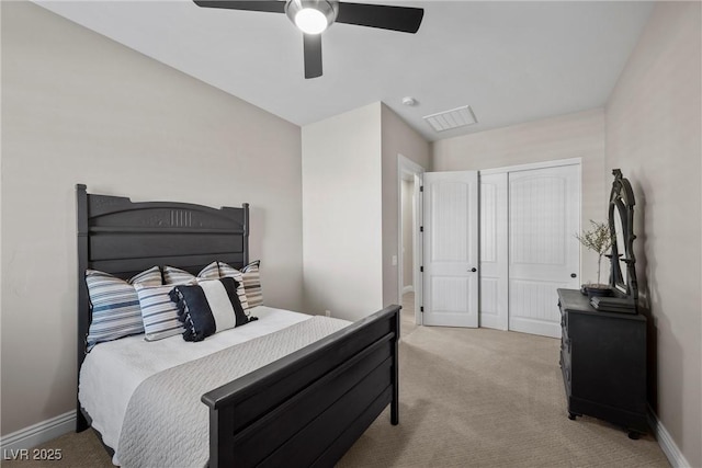 carpeted bedroom featuring ceiling fan and a closet