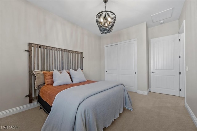 bedroom featuring light carpet, a closet, and a chandelier