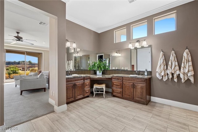 bathroom featuring ceiling fan, vanity, and ornamental molding