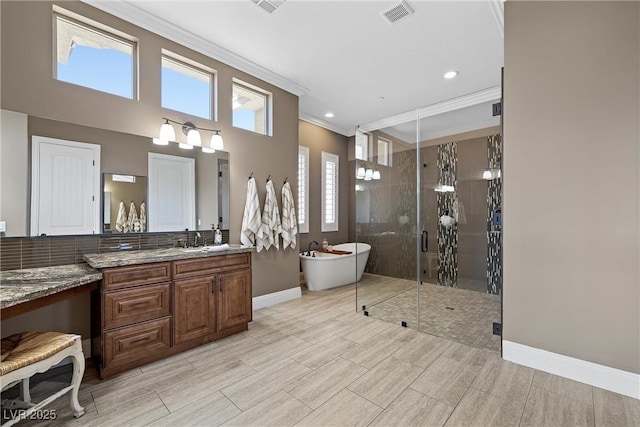 bathroom with vanity, crown molding, and plus walk in shower