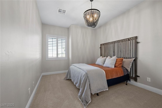 carpeted bedroom featuring a chandelier