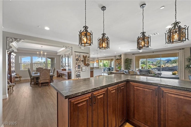 kitchen featuring ceiling fan, plenty of natural light, pendant lighting, and hardwood / wood-style flooring