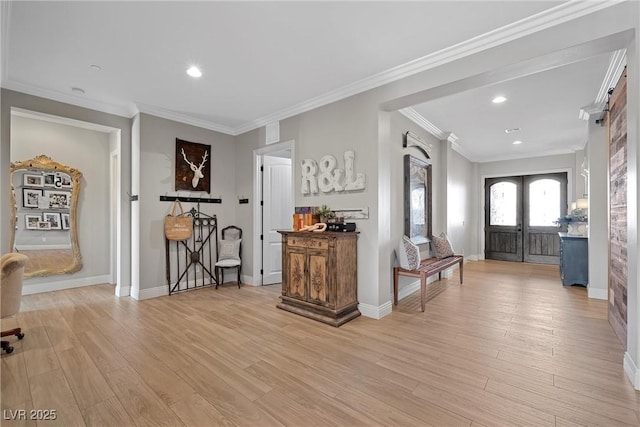 entryway with ornamental molding, light hardwood / wood-style flooring, and french doors