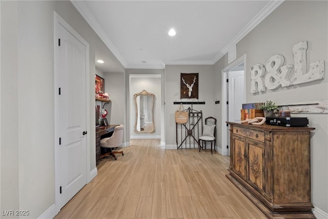 hall featuring crown molding and light hardwood / wood-style floors