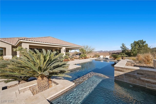 view of pool with a jacuzzi and a patio area