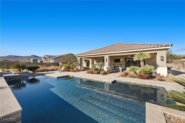 view of pool featuring a patio area and a mountain view