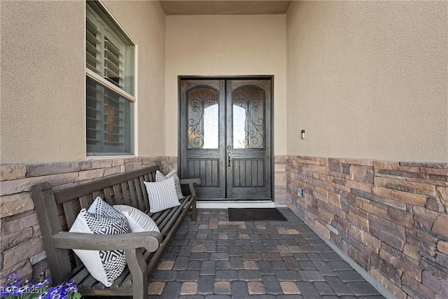 view of exterior entry featuring french doors