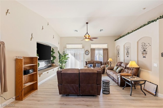 living room with vaulted ceiling, ceiling fan, and light hardwood / wood-style floors