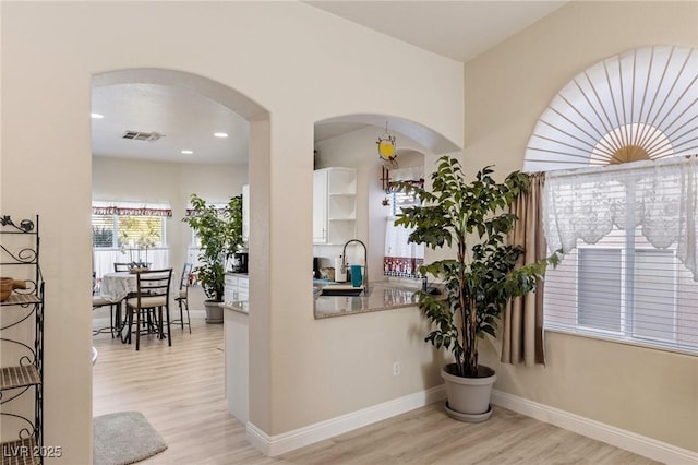 interior space with sink and light hardwood / wood-style flooring