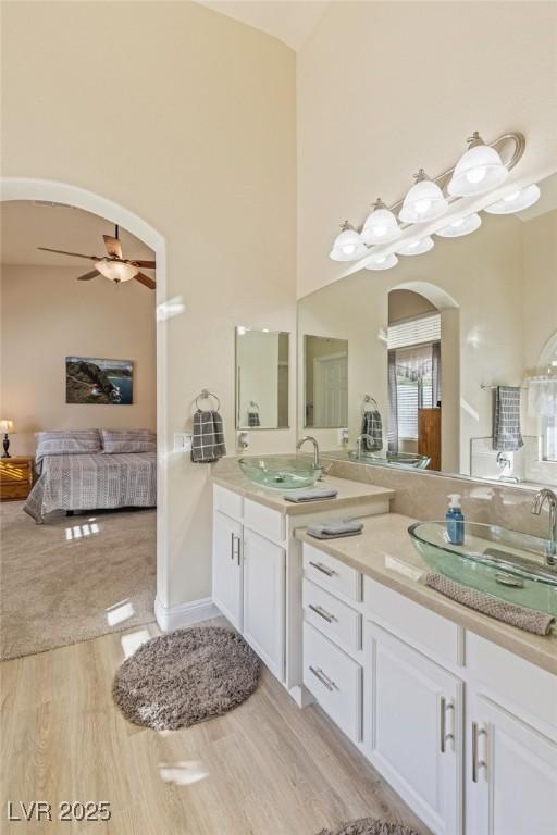 bathroom with ceiling fan, vanity, and hardwood / wood-style flooring