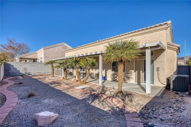 rear view of house with a patio and central AC