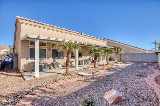 rear view of house with a patio