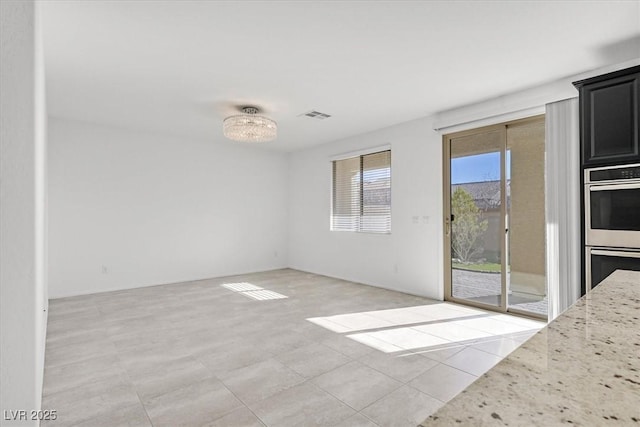 interior space featuring an inviting chandelier and light tile patterned floors