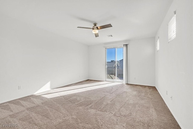 carpeted empty room with ceiling fan and a healthy amount of sunlight