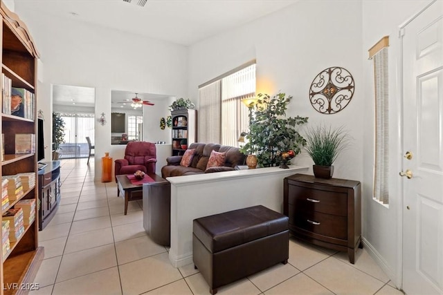 tiled living room with ceiling fan