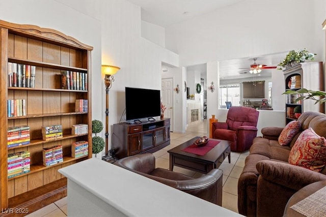 living room featuring ceiling fan and light tile patterned flooring