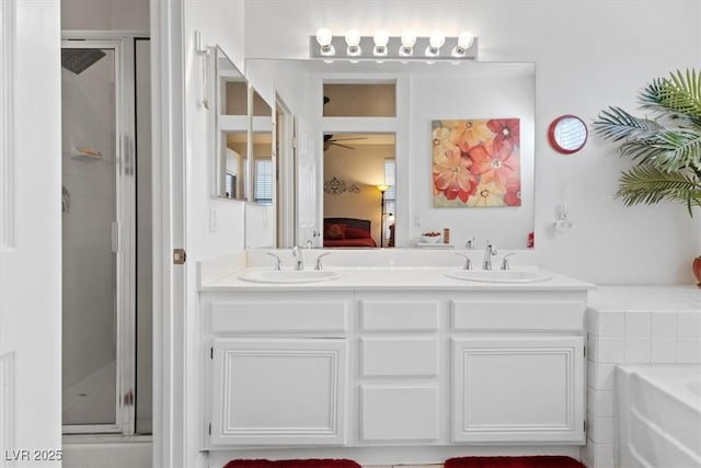 bathroom featuring vanity and independent shower and bath