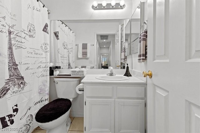 bathroom featuring vanity, tile patterned floors, and toilet