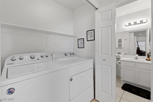 laundry room featuring sink, washing machine and dryer, and light tile patterned floors