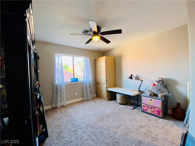 interior space featuring ceiling fan and light colored carpet