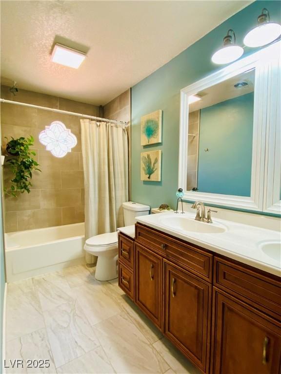 full bathroom with toilet, vanity, and shower / bath combo with shower curtain