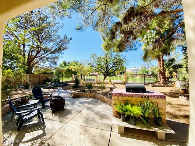 view of patio featuring an outdoor fire pit and area for grilling