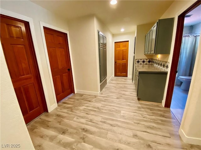 corridor with light hardwood / wood-style floors