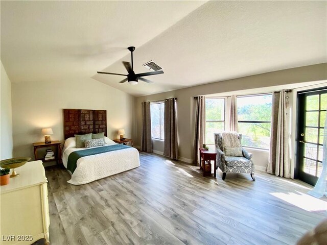 bedroom with light wood-type flooring, ceiling fan, vaulted ceiling, and access to exterior