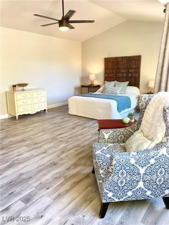 bedroom featuring vaulted ceiling, ceiling fan, and hardwood / wood-style flooring