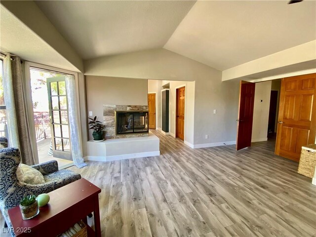 living room featuring light hardwood / wood-style floors and vaulted ceiling