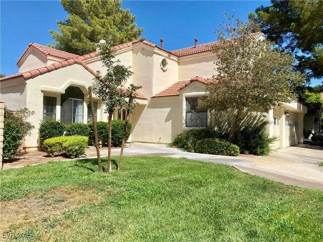 mediterranean / spanish-style home with a front yard