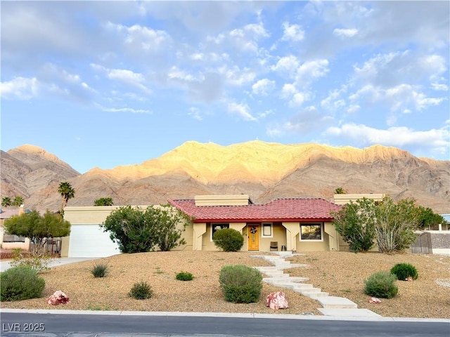 view of front facade featuring a garage and a mountain view