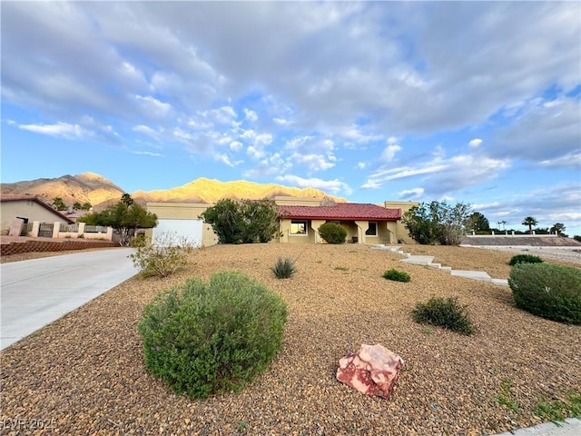 view of front of property featuring a garage and a mountain view