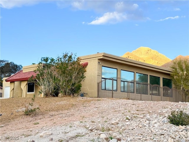 back of house featuring a mountain view