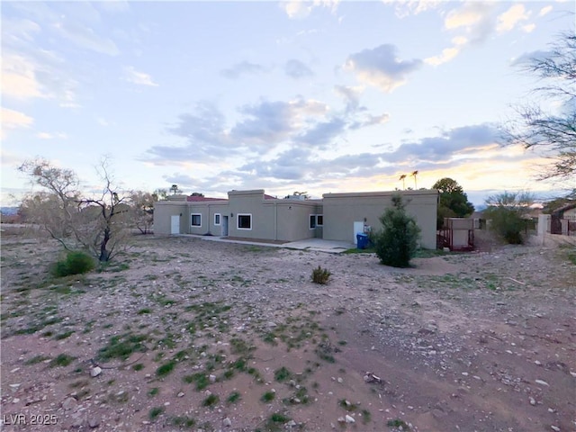 view of back house at dusk