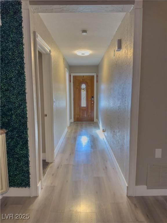 corridor with light hardwood / wood-style flooring