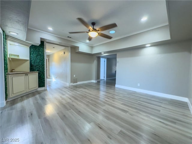 unfurnished living room featuring ceiling fan, light hardwood / wood-style floors, and crown molding