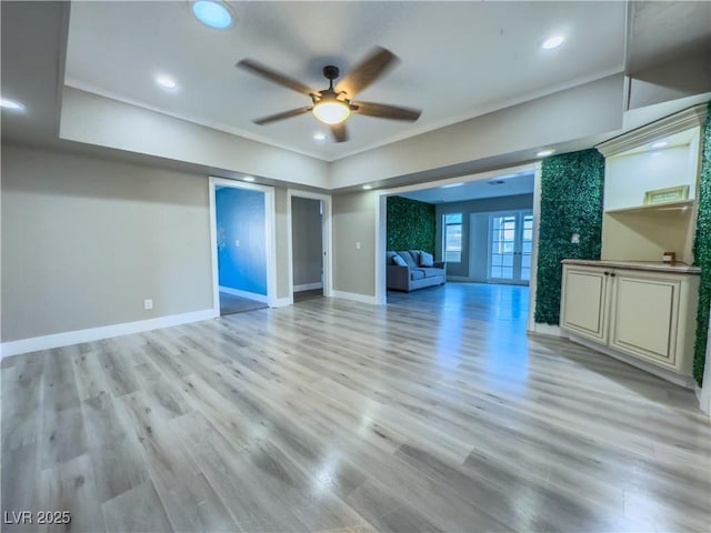 unfurnished living room with ceiling fan, light hardwood / wood-style floors, and crown molding