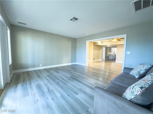 unfurnished living room with ceiling fan and hardwood / wood-style flooring