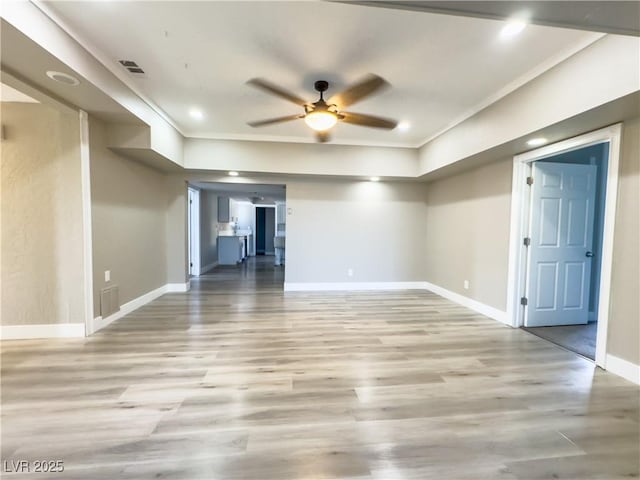 interior space with ceiling fan, crown molding, and light hardwood / wood-style flooring