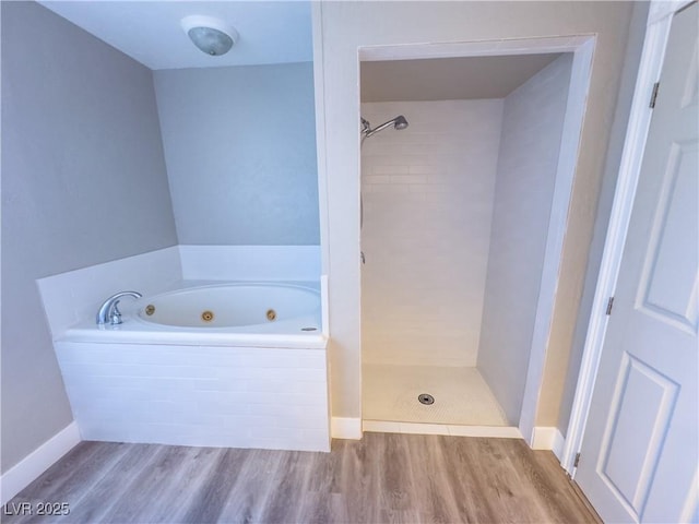 bathroom featuring hardwood / wood-style flooring and plus walk in shower