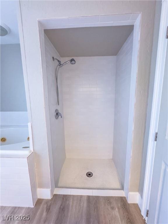 bathroom featuring separate shower and tub and hardwood / wood-style floors