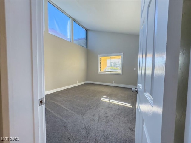 empty room featuring dark carpet