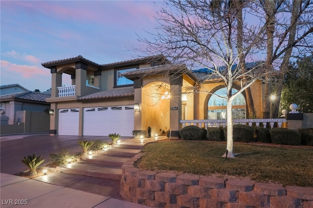 mediterranean / spanish house featuring a lawn and a garage