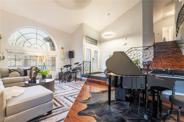 living room featuring hardwood / wood-style floors, french doors, and vaulted ceiling