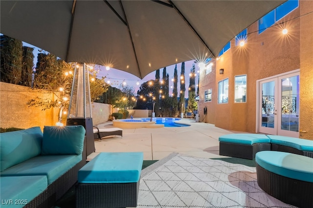 patio at twilight featuring a fenced in pool, an outdoor living space, and french doors