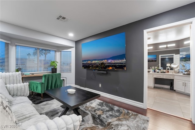 living room featuring built in desk and hardwood / wood-style flooring